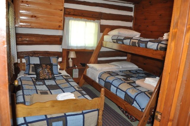 A bedroom with two bunk beds and a single bed