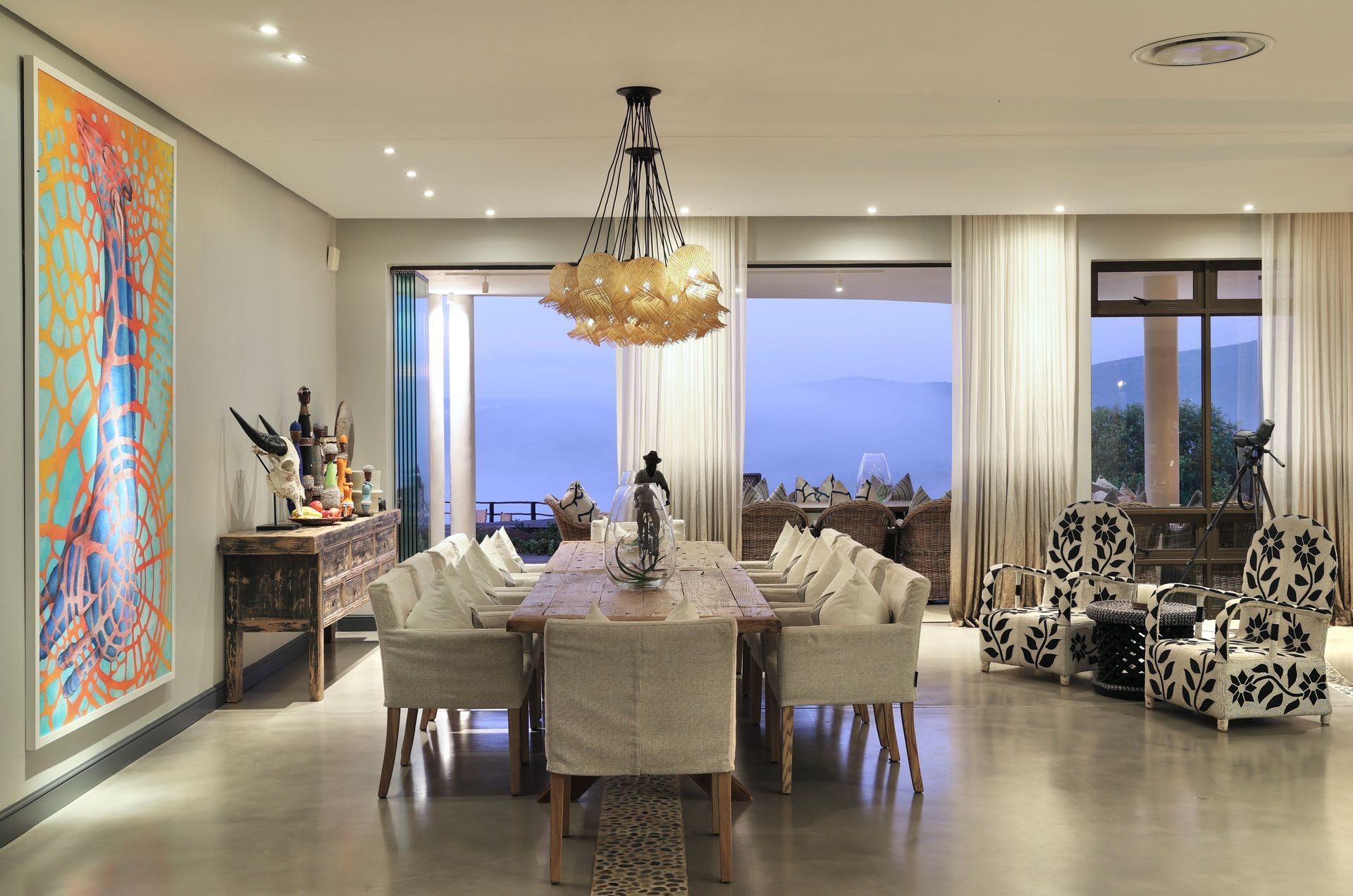 A large dining room with a long table and chairs
