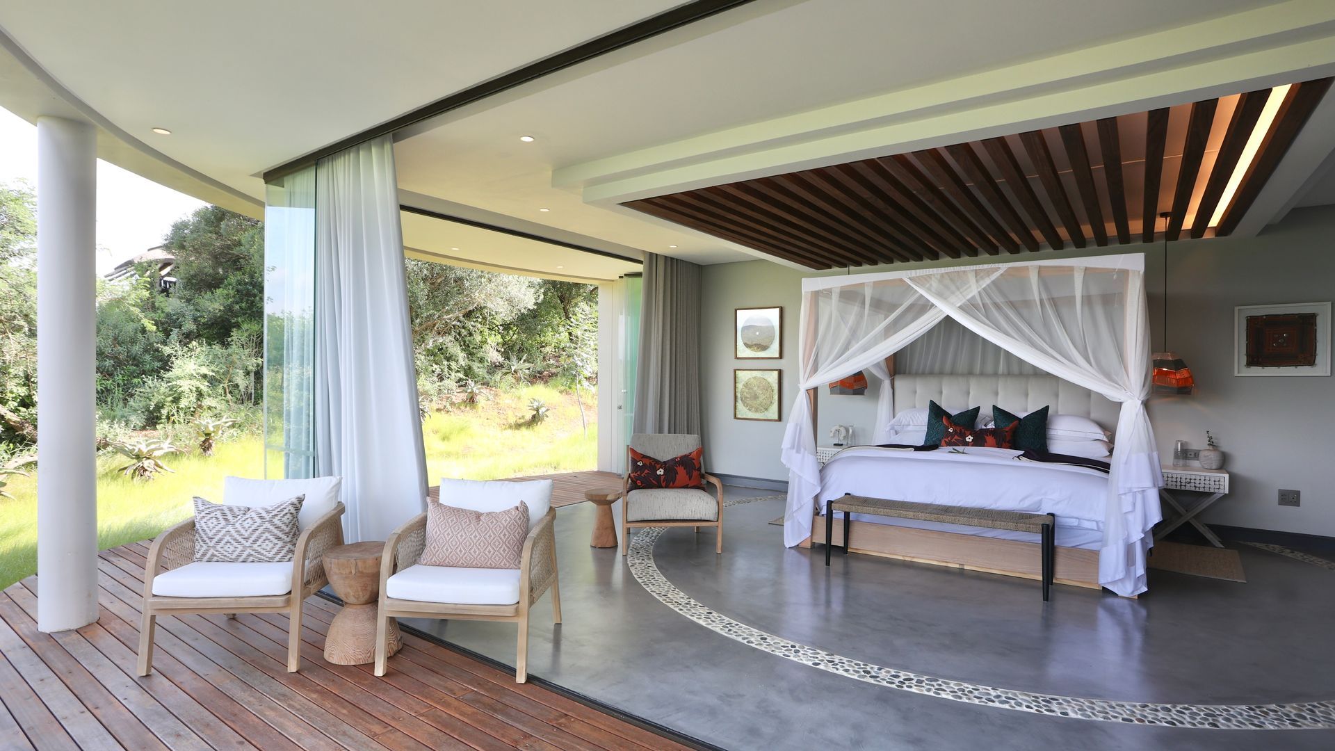 There is a canopy bed in the middle of the room.