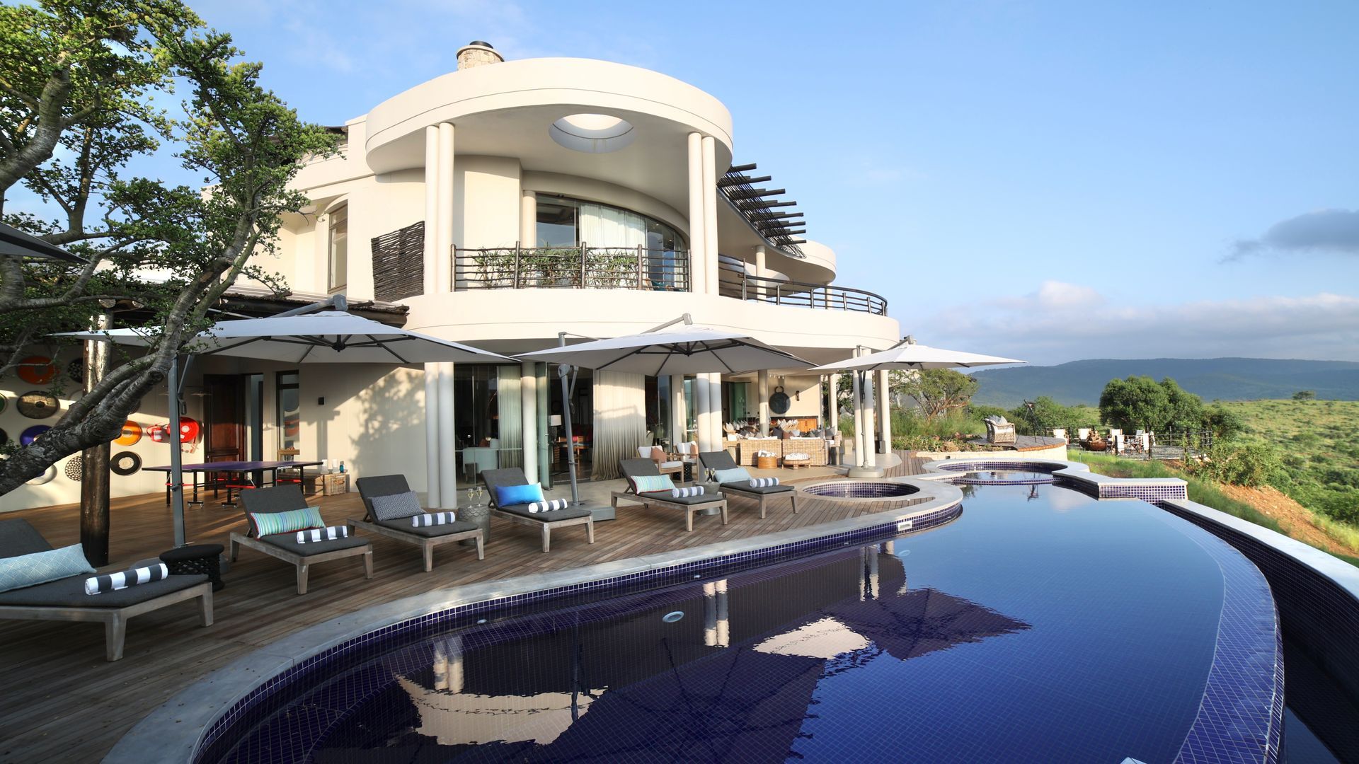A large house with a swimming pool in front of it