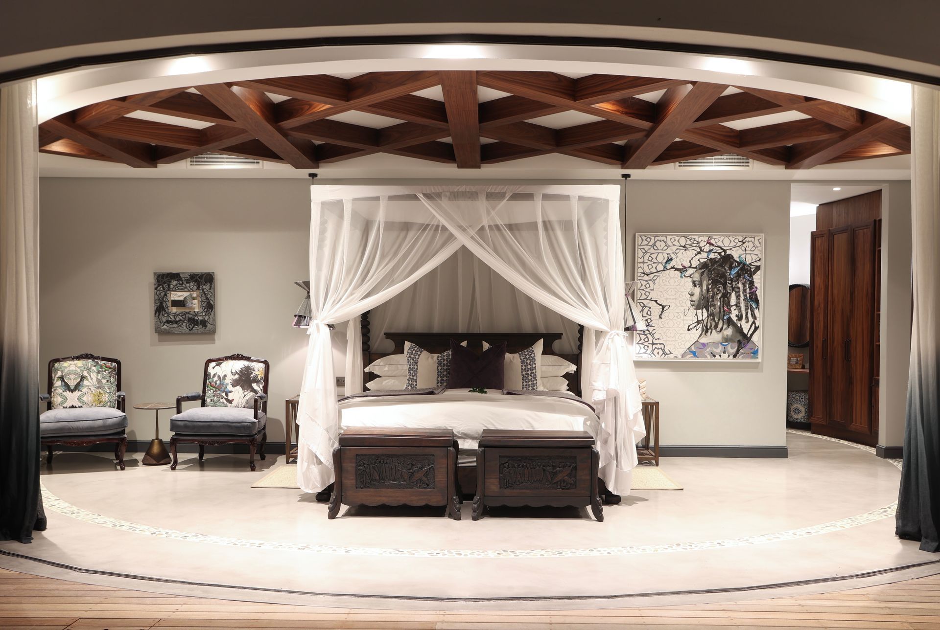 There is a canopy bed in the middle of the room.