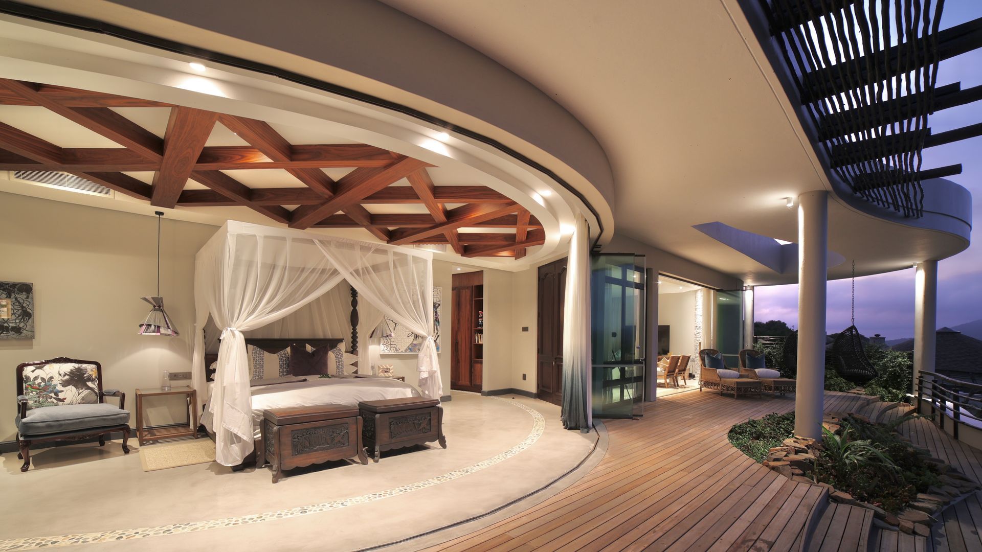 A bedroom with a canopy bed and a balcony