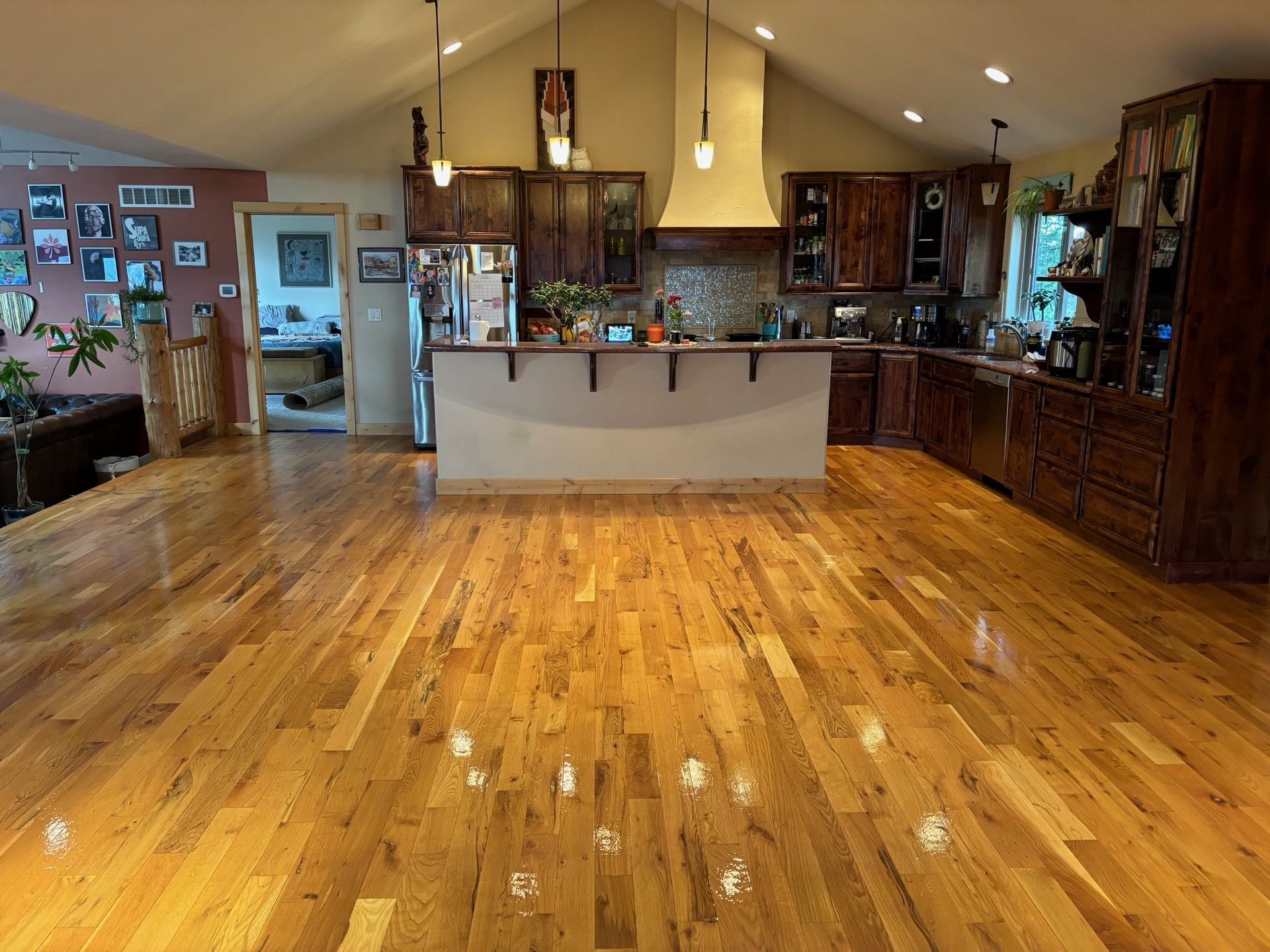 A kitchen with hardwood floors and a large island