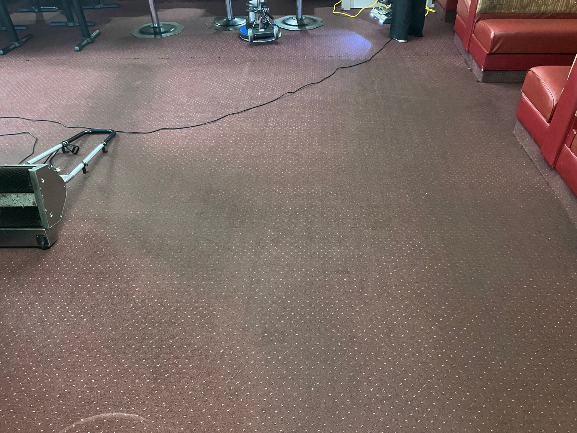 A vacuum cleaner is sitting on the floor in a living room.