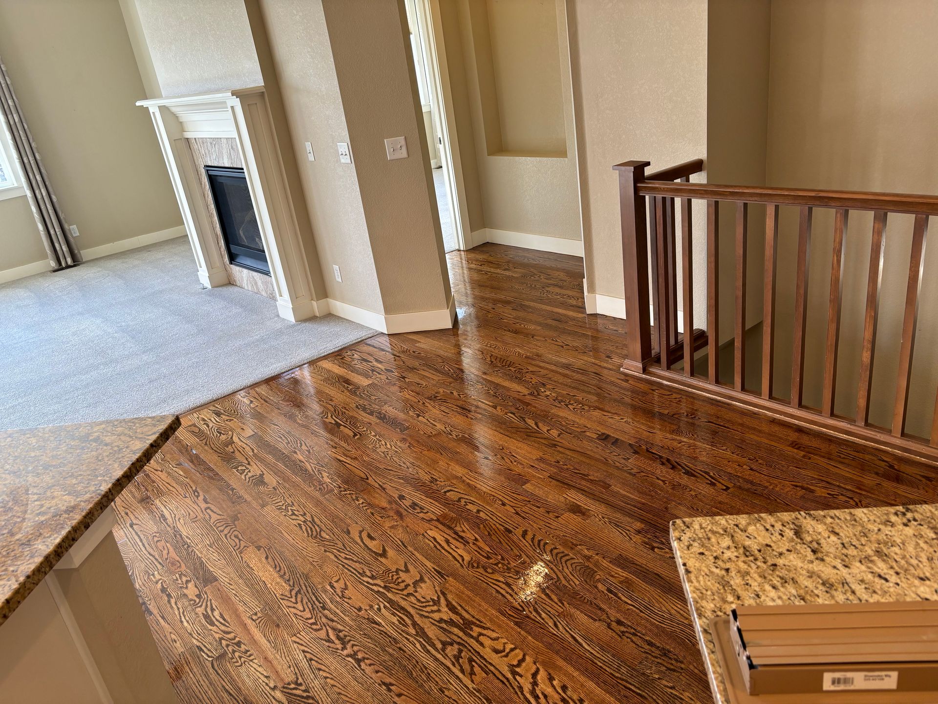 A living room with hardwood floors and a fireplace.