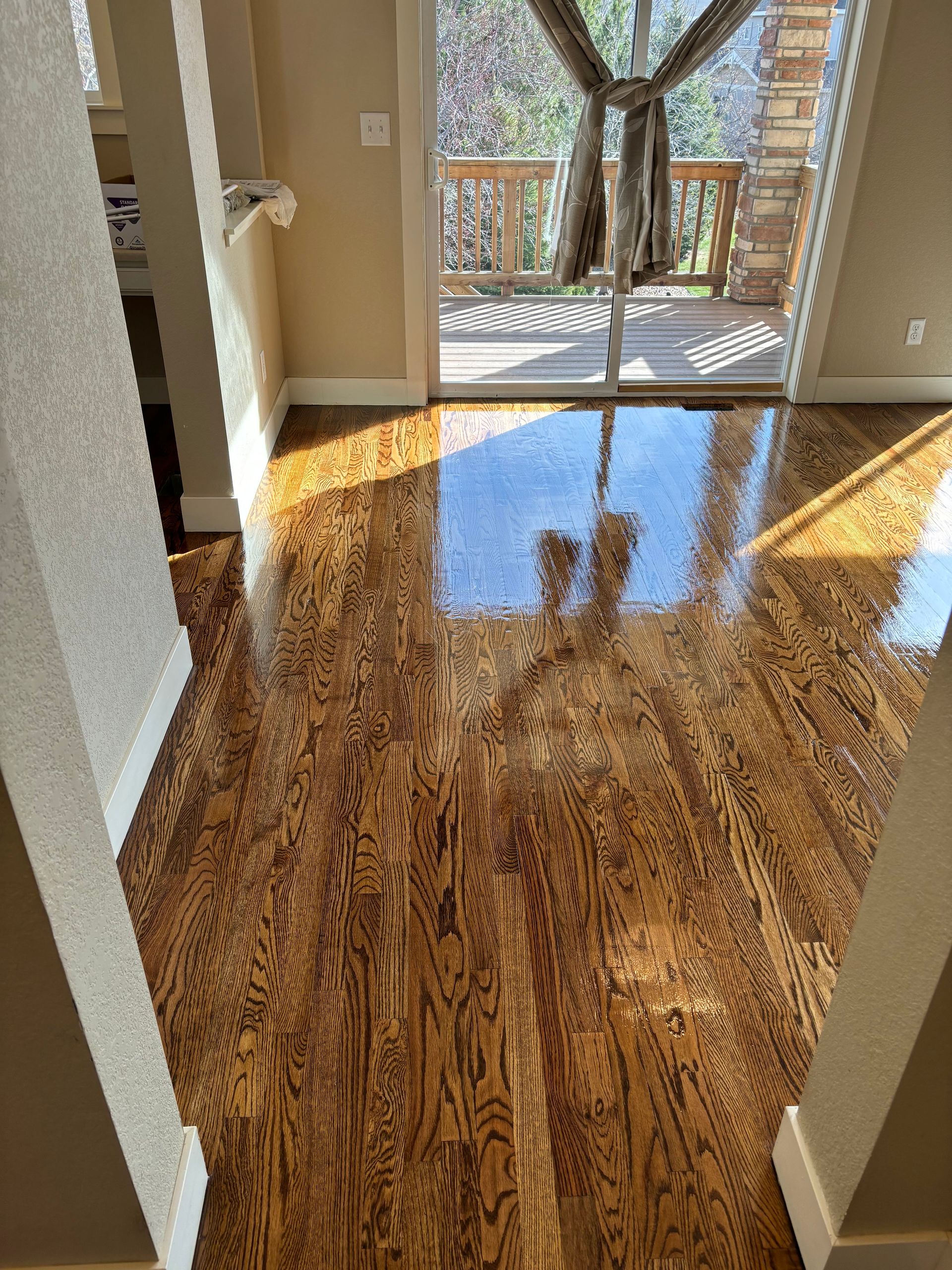 A living room with hardwood floors and a sliding glass door.