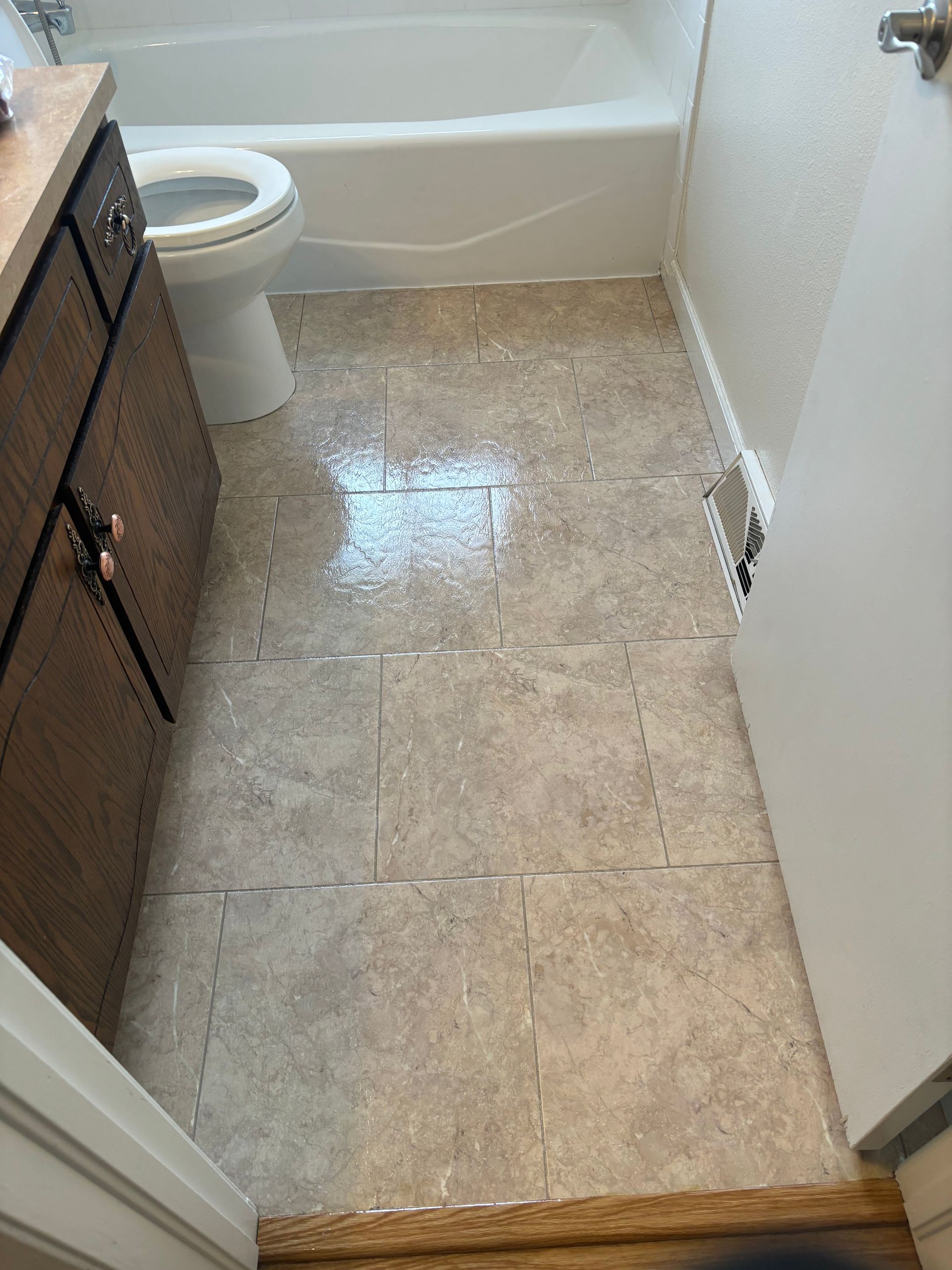 A bathroom with a toilet , sink and bathtub.
