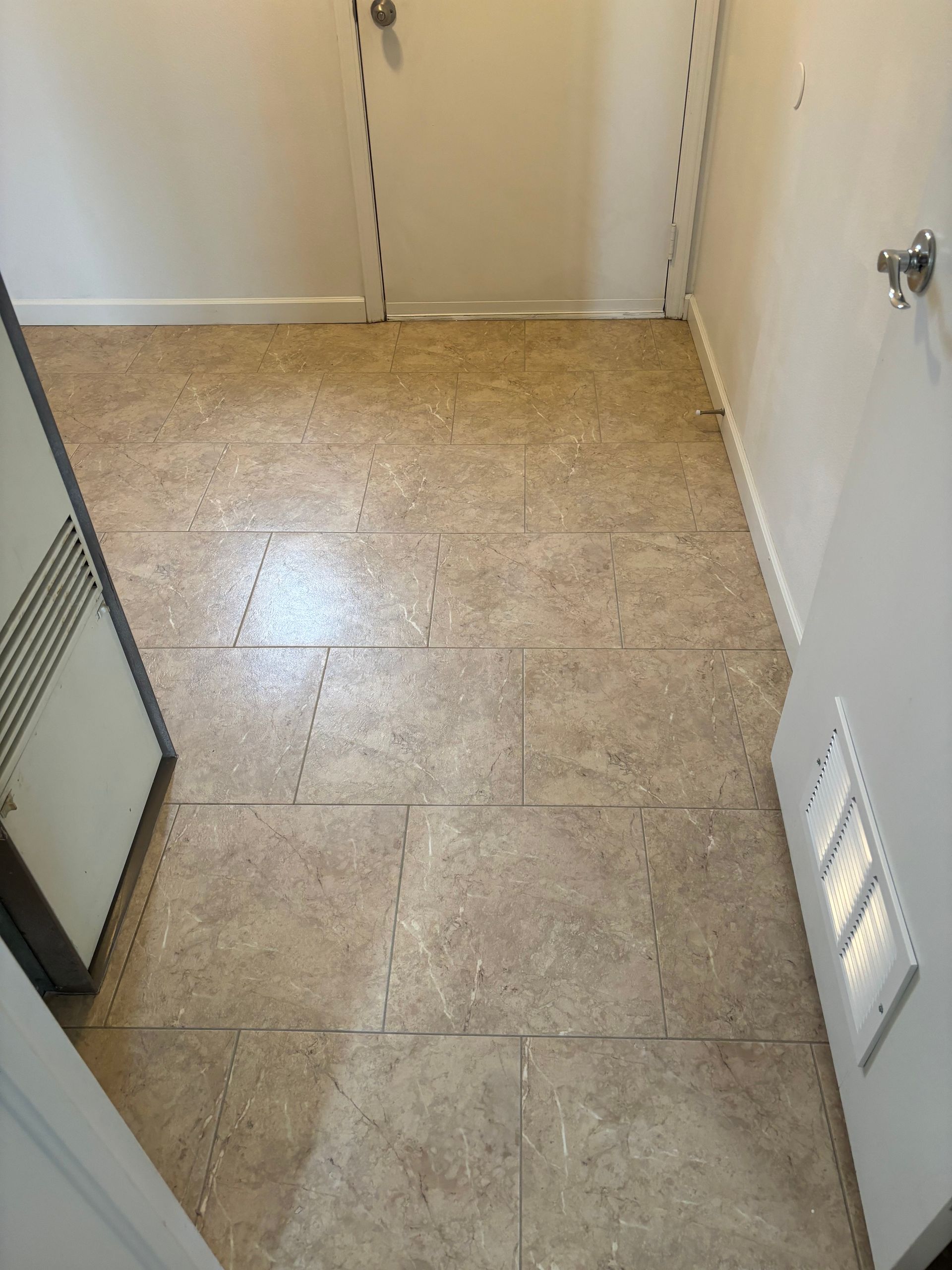 A room with a tiled floor and white walls