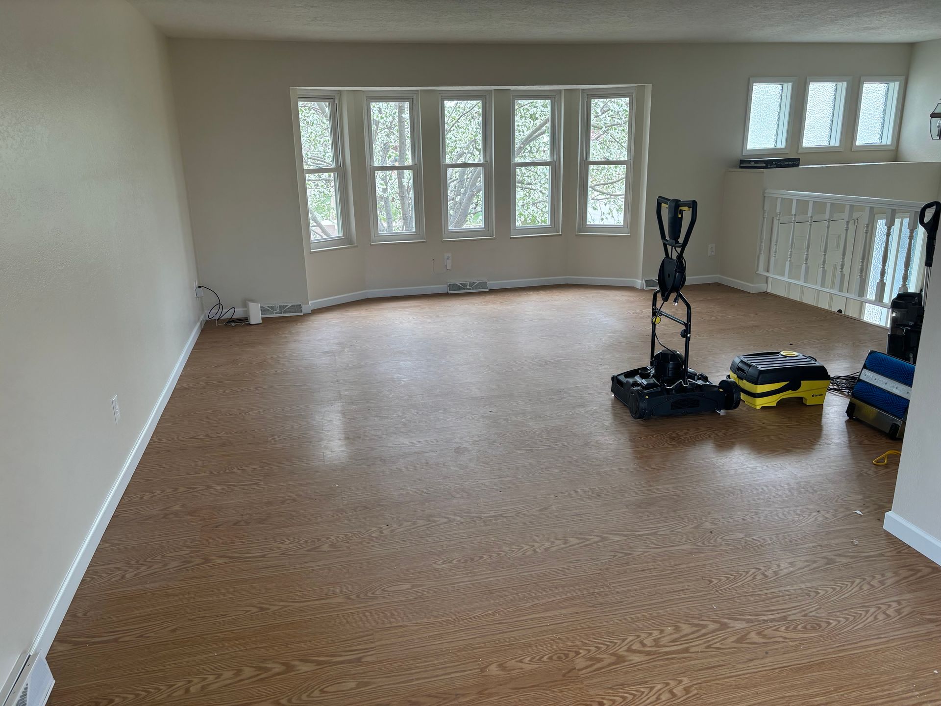 An empty room with a vacuum cleaner on the floor.