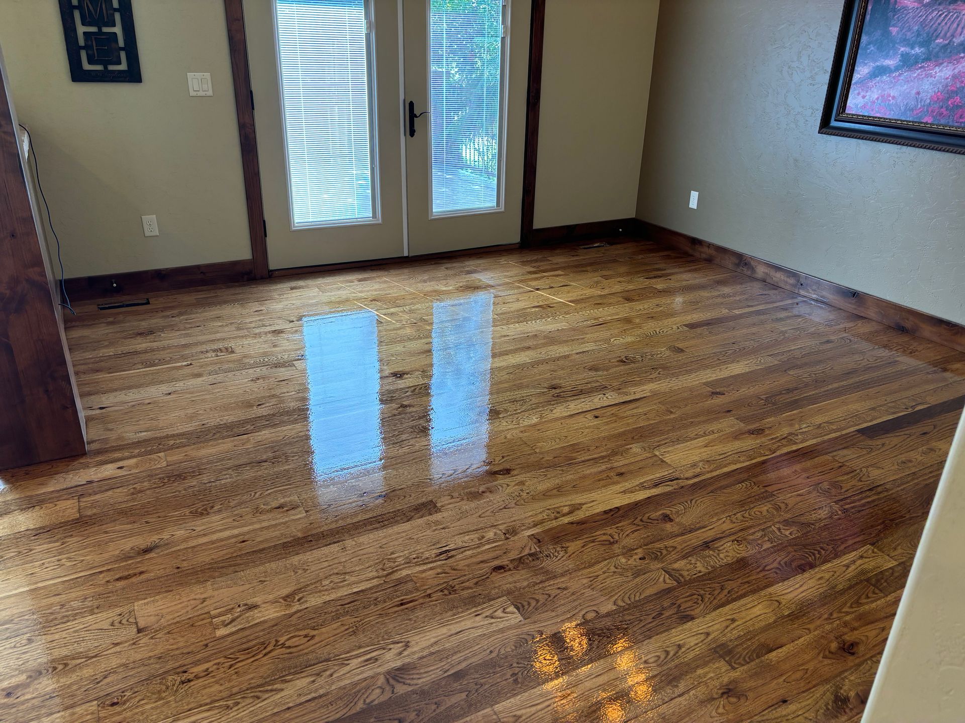 A living room with hardwood floors and a sliding glass door.