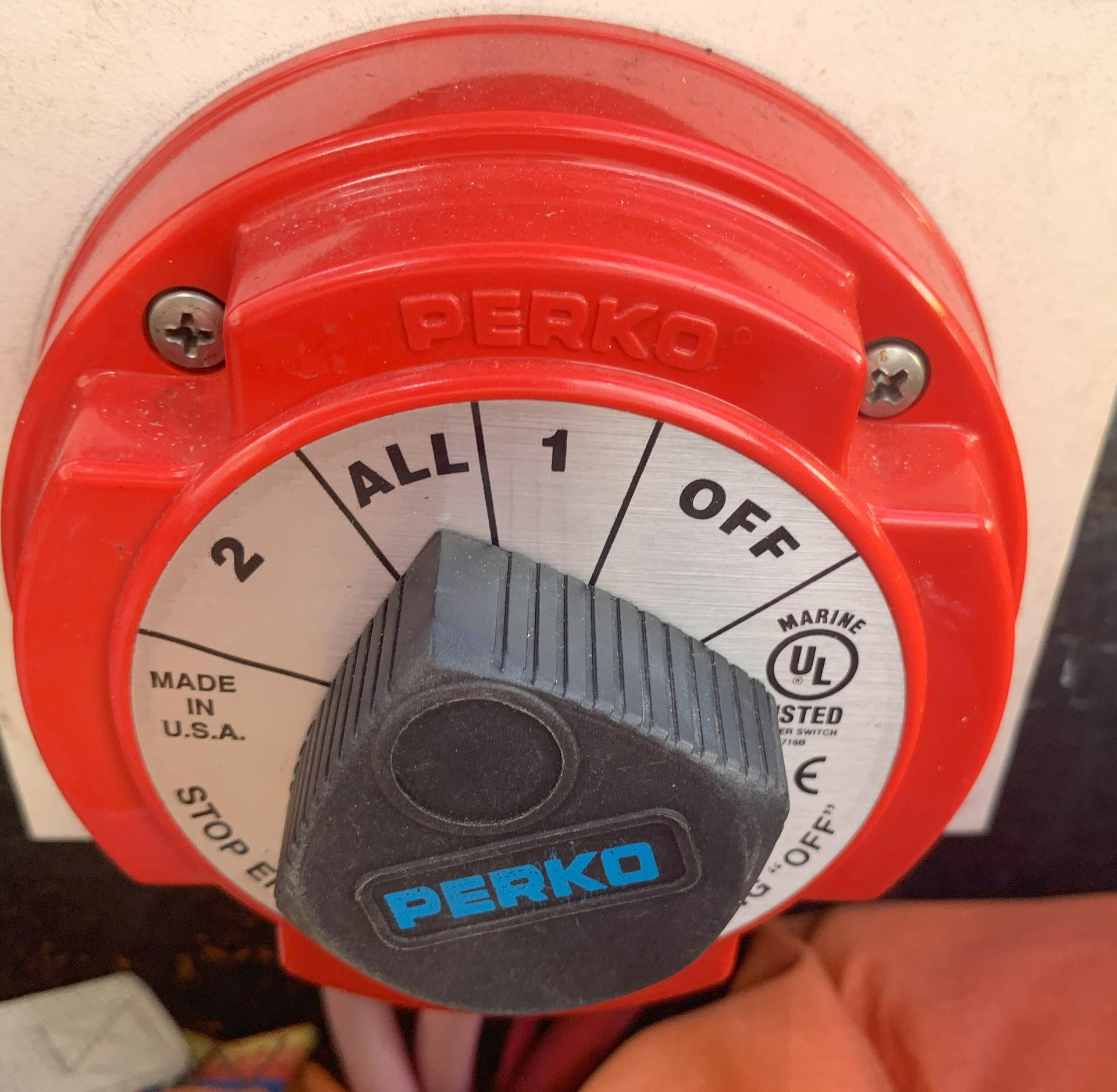 Red Perko marine switch with black knob set to the 1 position