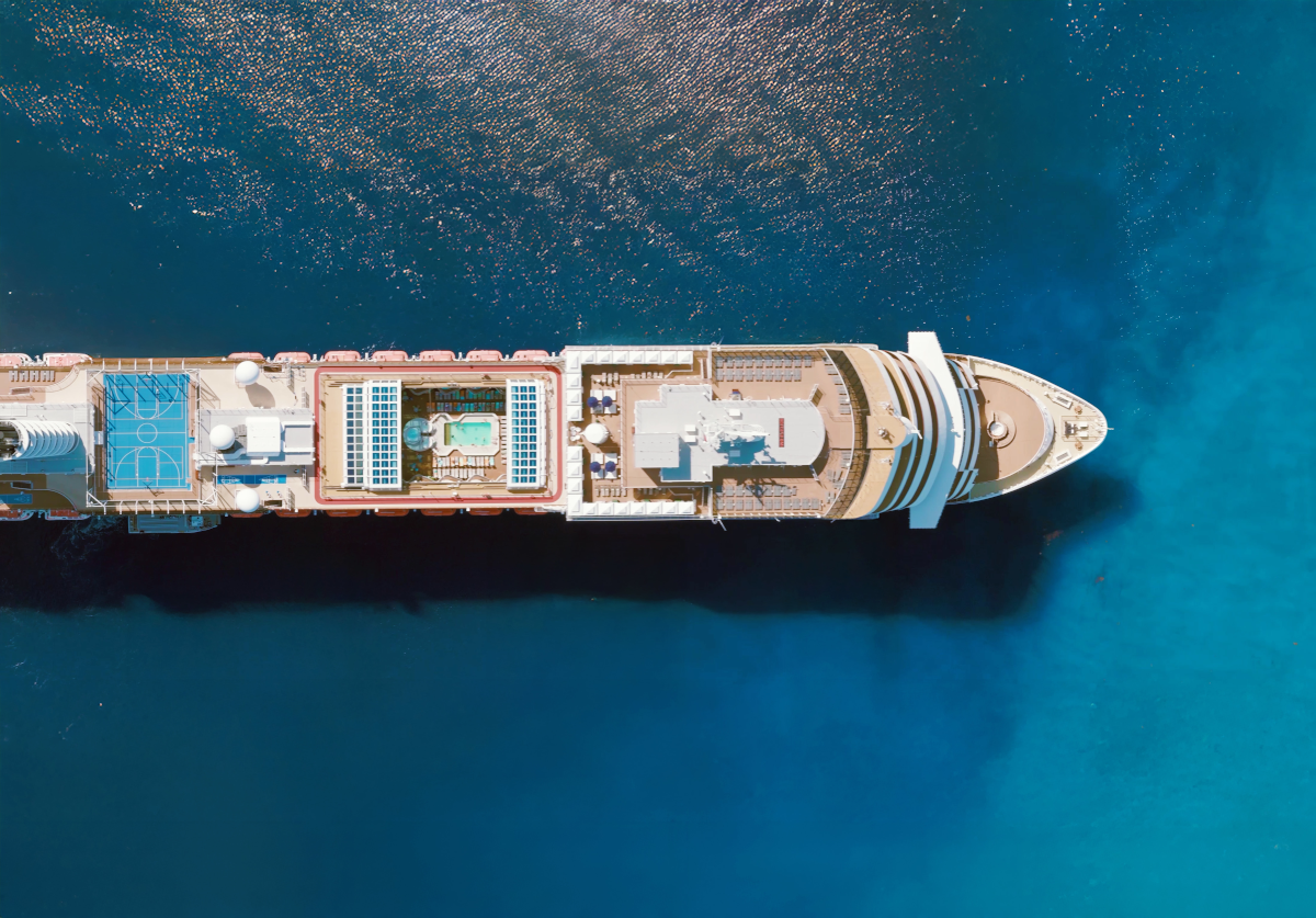 Cruise ship on blue water, seen from above.