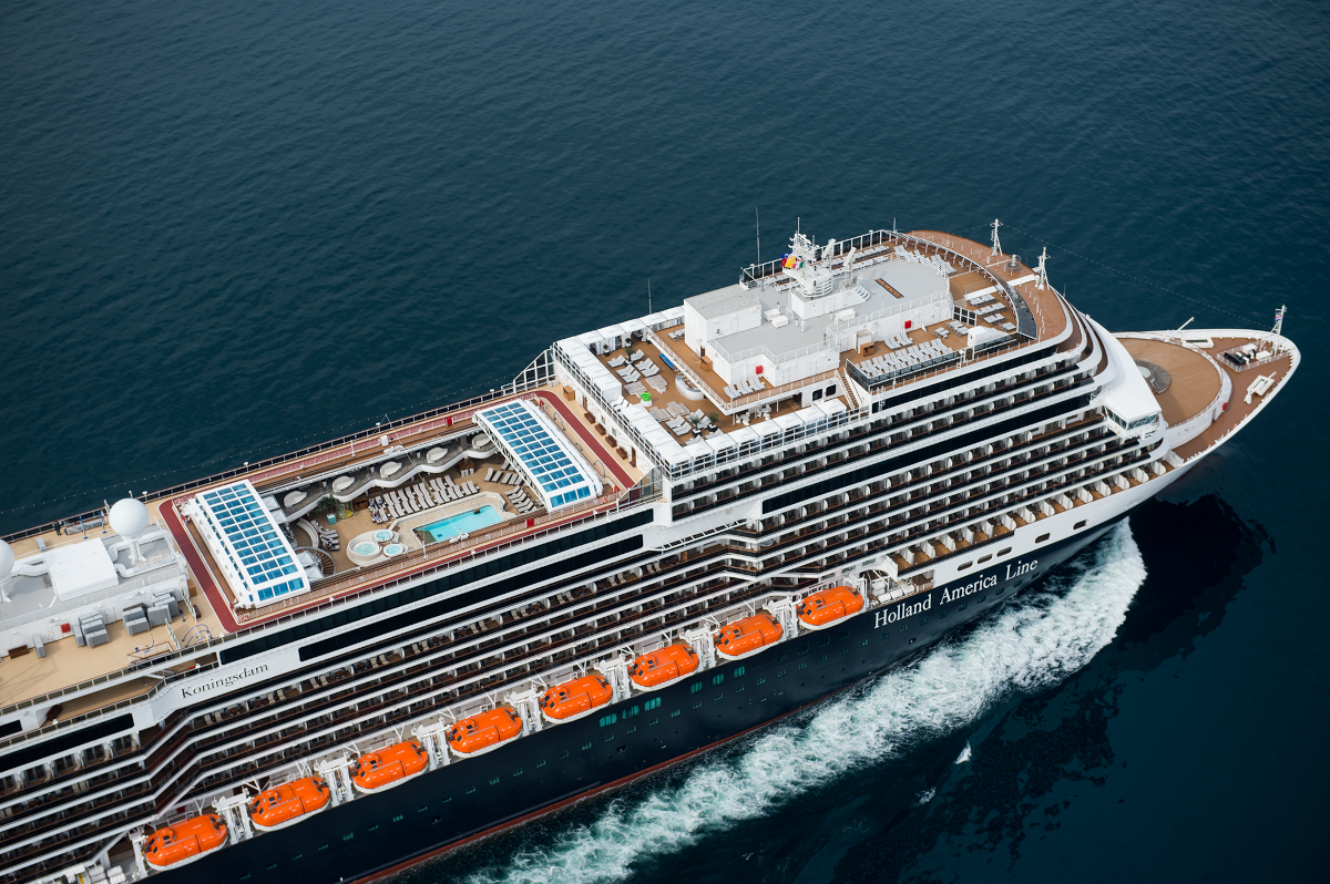 An ariel view of the MS Koningsdam as it sails through blue waters
