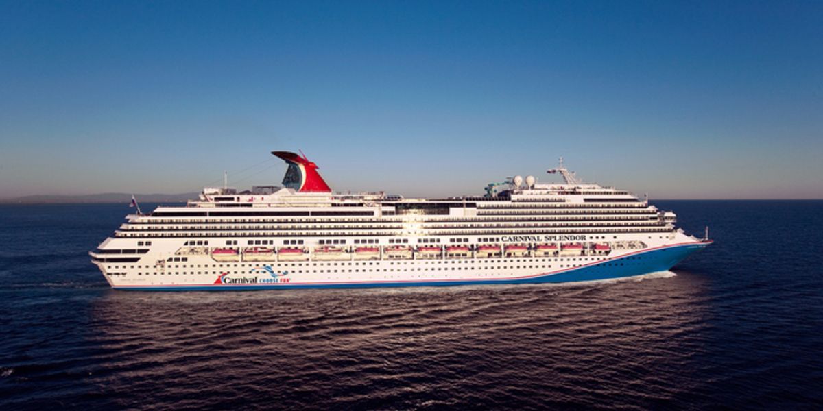 Cruise ship sailing on a blue sea under a clear sky.