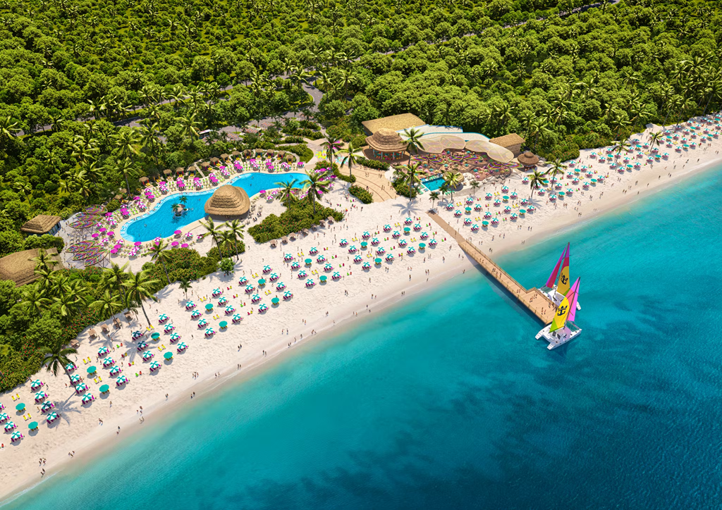 Aerial view of a tropical beach resort with pool, beach umbrellas, pier, and lush green vegetation.