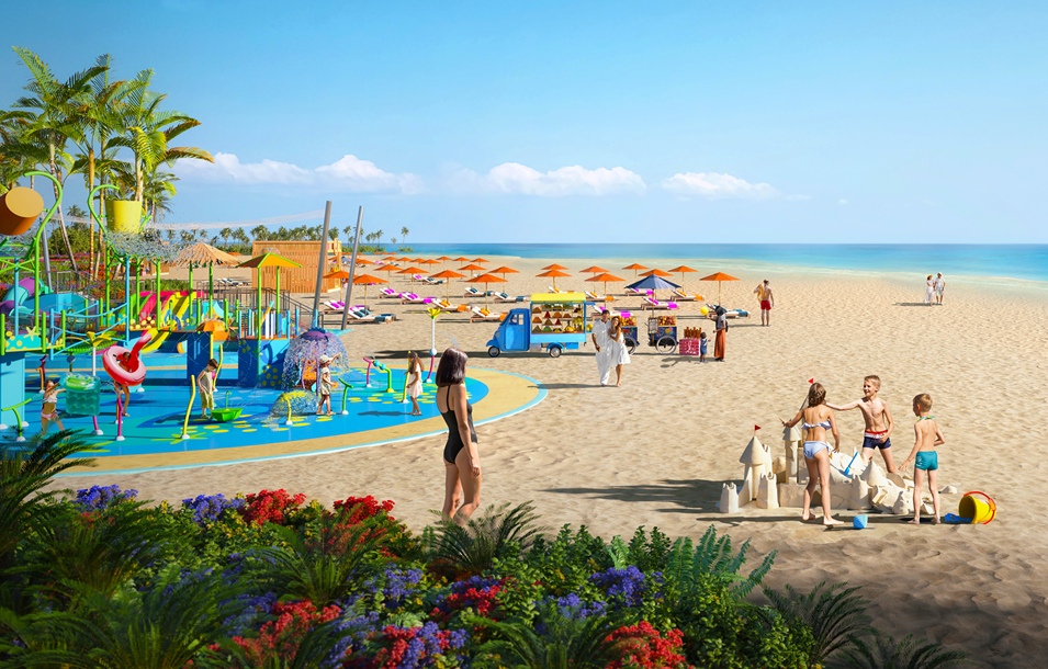 Beach with children playing in a colorful water park, sunbathers, and clear blue water under a sunny sky.