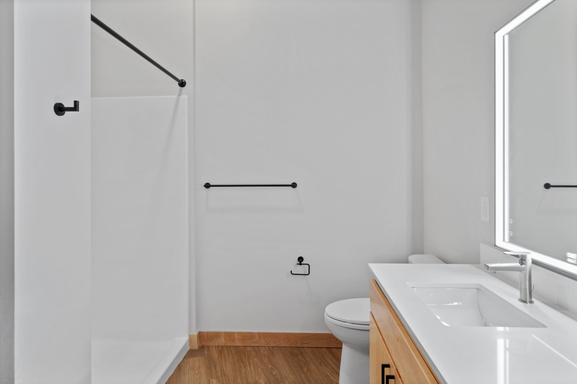 A bathroom with a toilet , sink , and mirror.