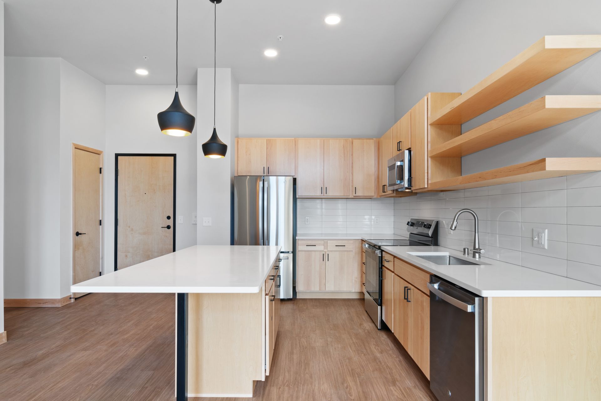 A kitchen with wooden cabinets and stainless steel appliances