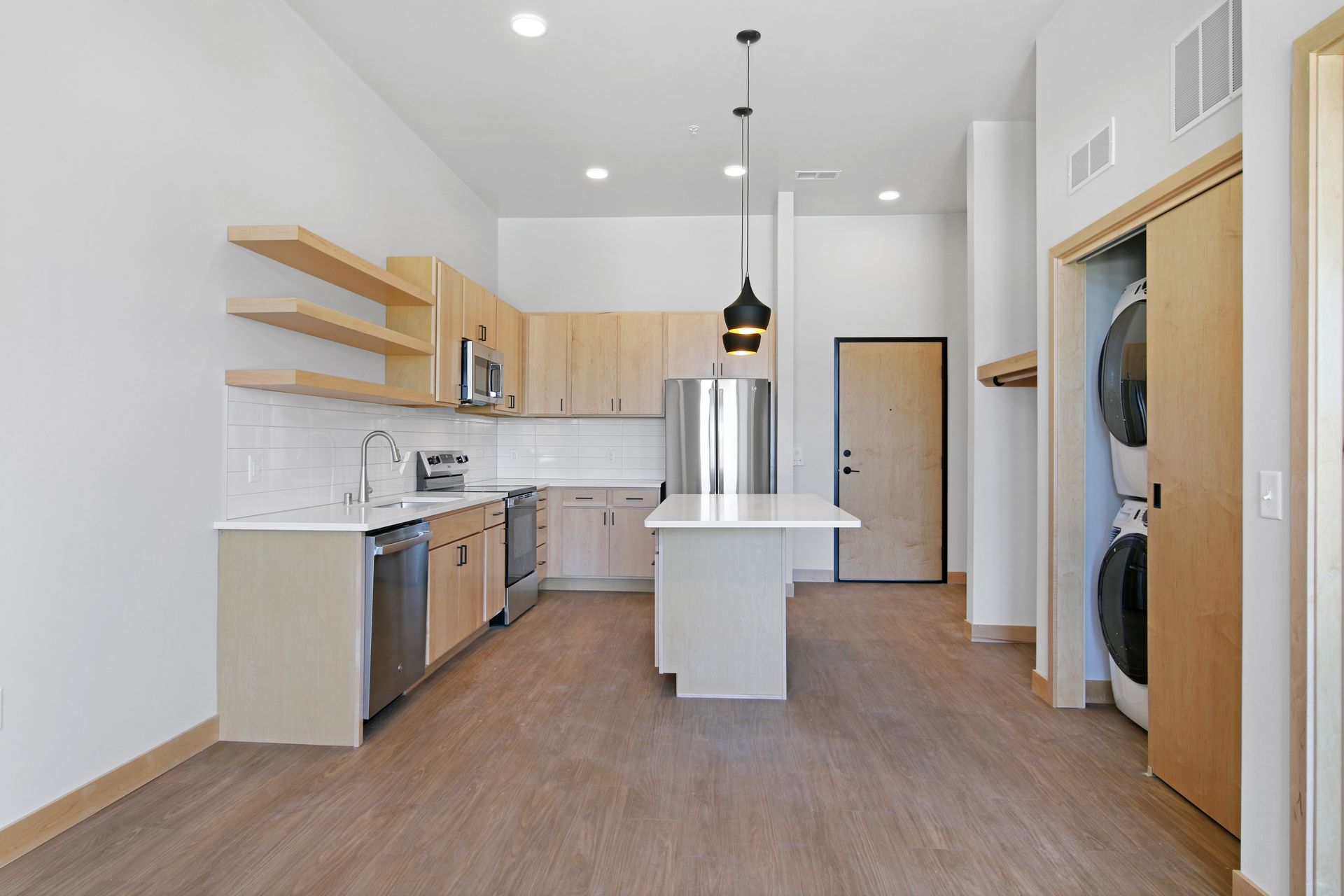 A kitchen with stainless steel appliances and wooden cabinets