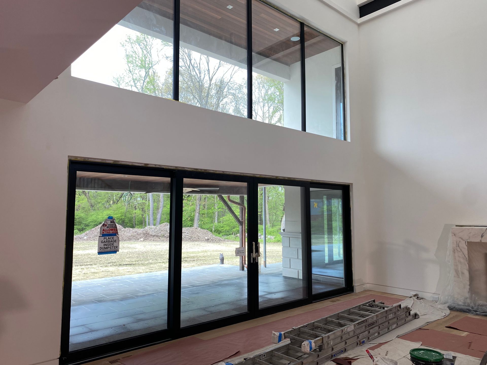 A large room with a lot of windows and a fireplace.