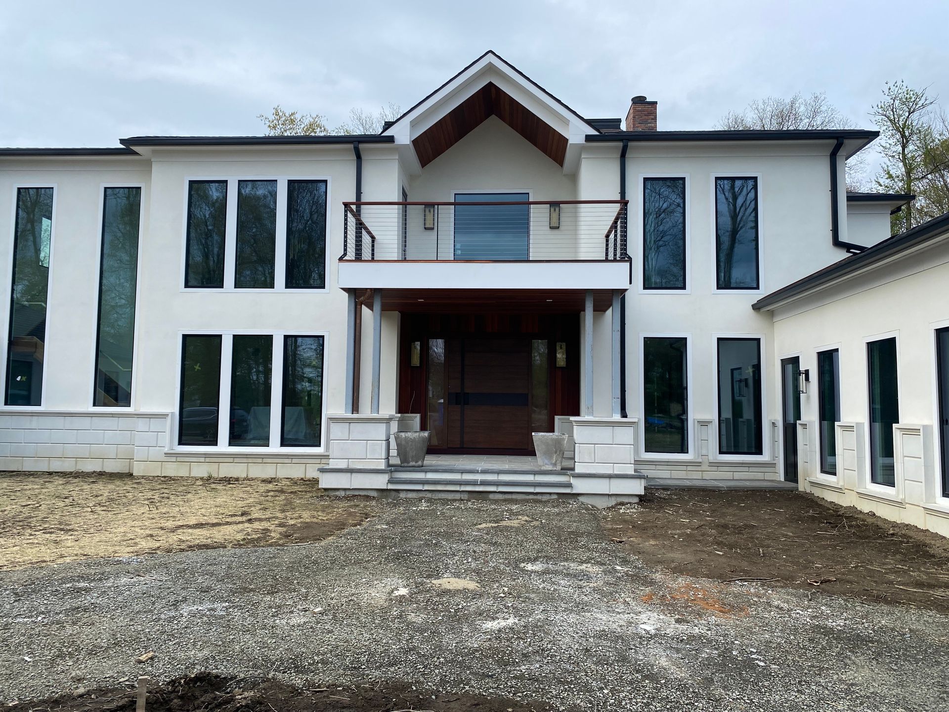 A large white house with a lot of windows and a balcony.
