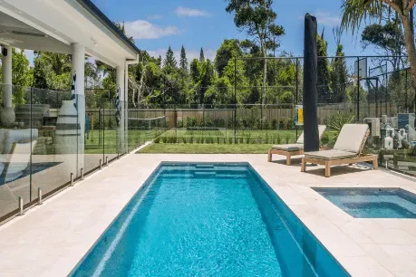 There Is A Large Swimming Pool In The Backyard Of A House — Evoke Pools In Lennox Head, NSW