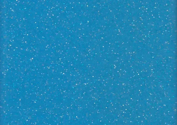 A close up of a blue surface with white glitter.