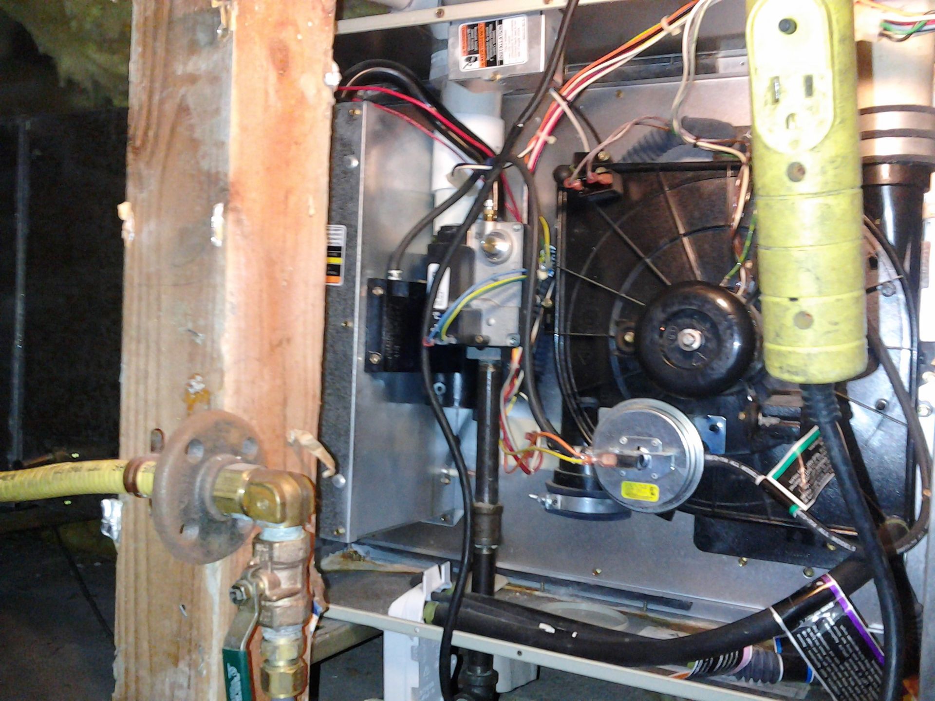 Gas furnace in crawlspace with yellow flexible gas line and blower assembly