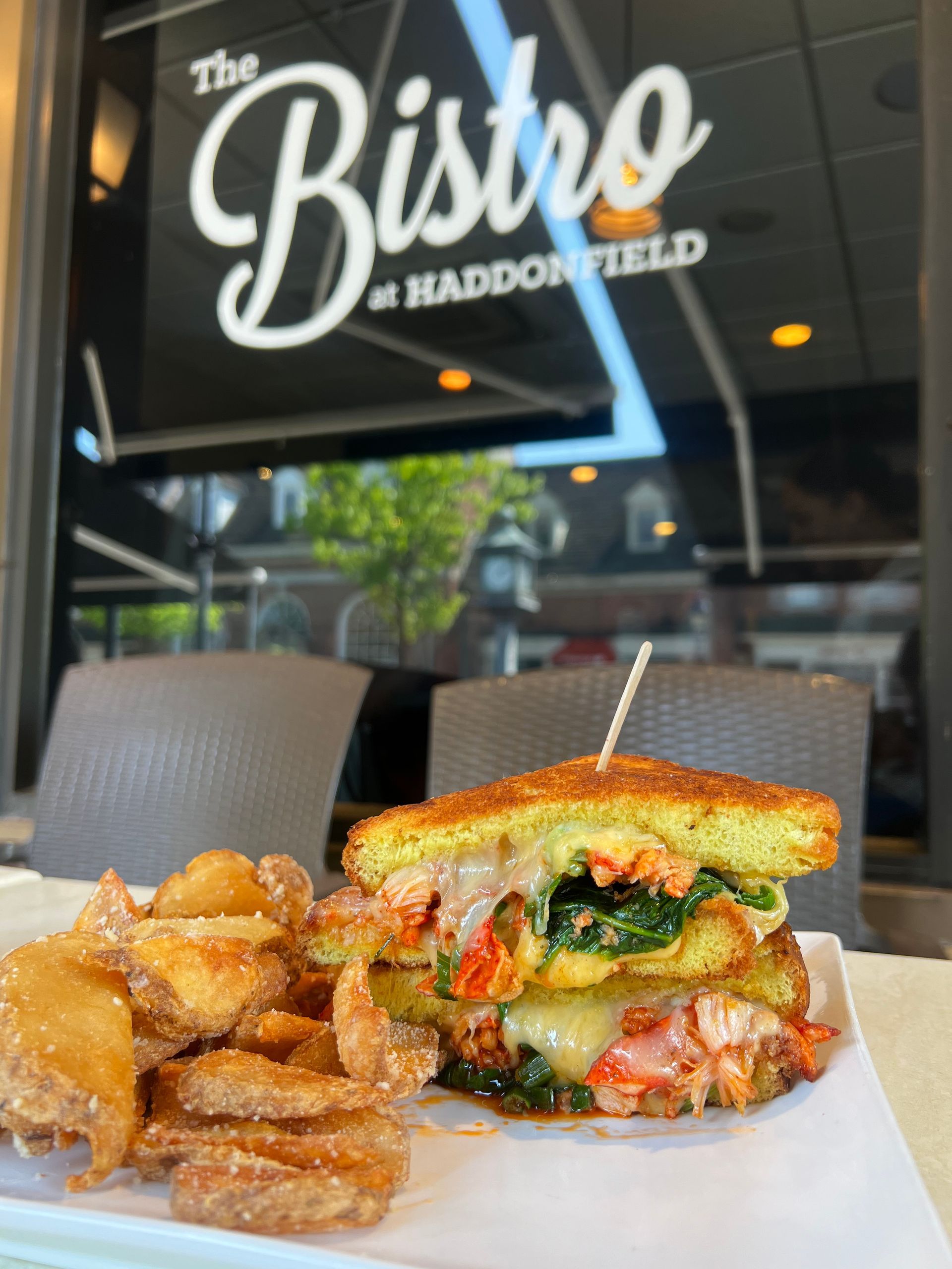 Sandwich and fries on a tray outside The Bistro at Haddonfield