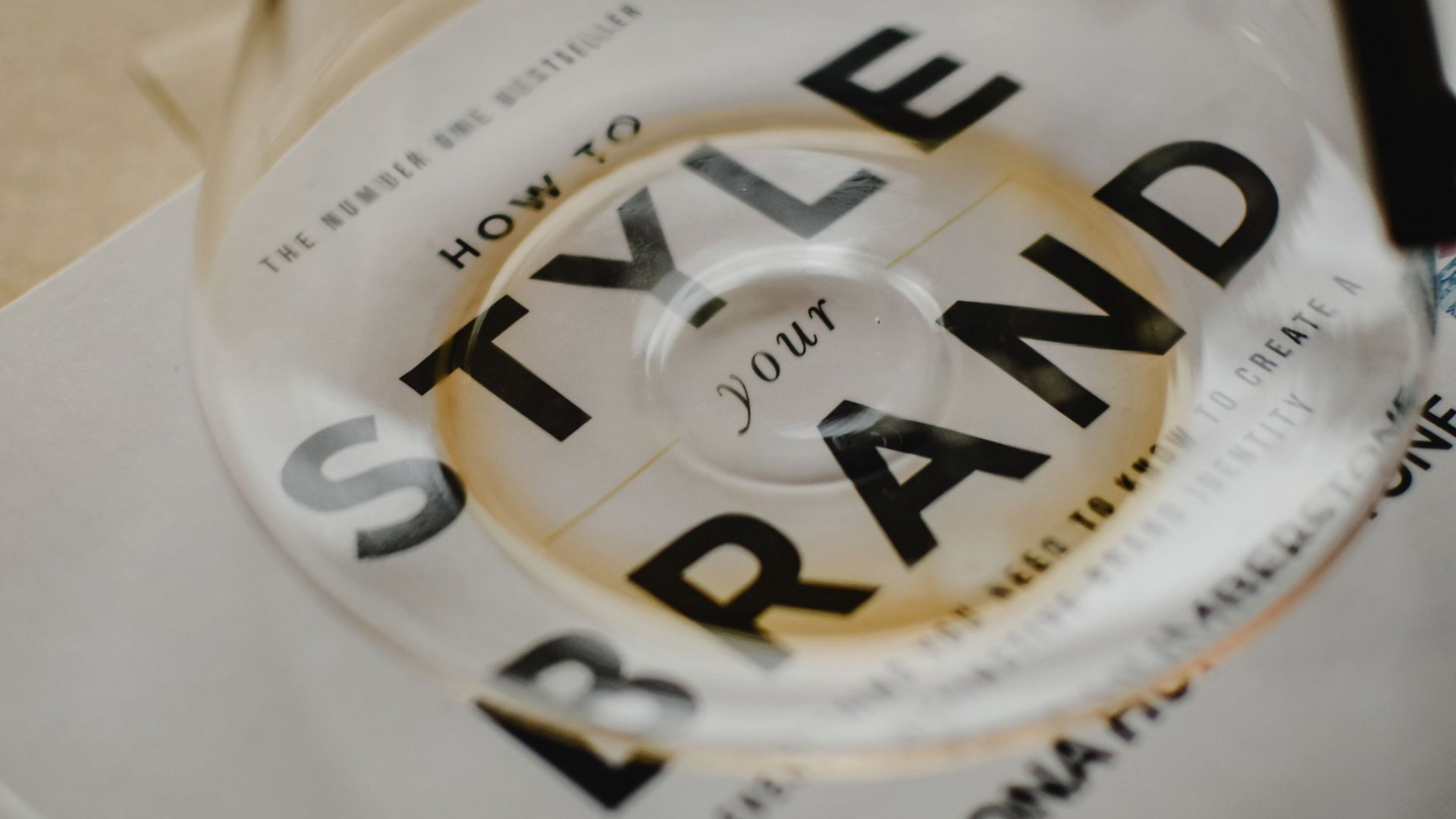 Close-up of a stylish brand logo on a white and gold package with bold black text.