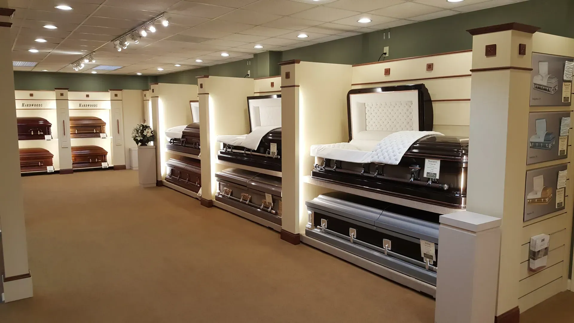 Furniture showroom with rows of mattresses and adjustable beds under bright ceiling lights