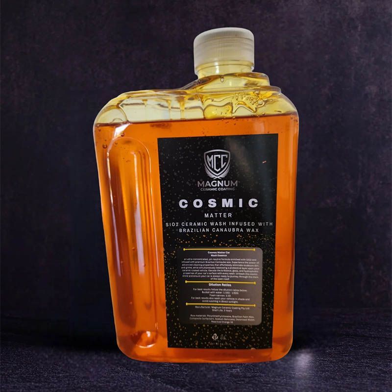 Amber whiskey bottle labeled “COSMIC” on a dark background