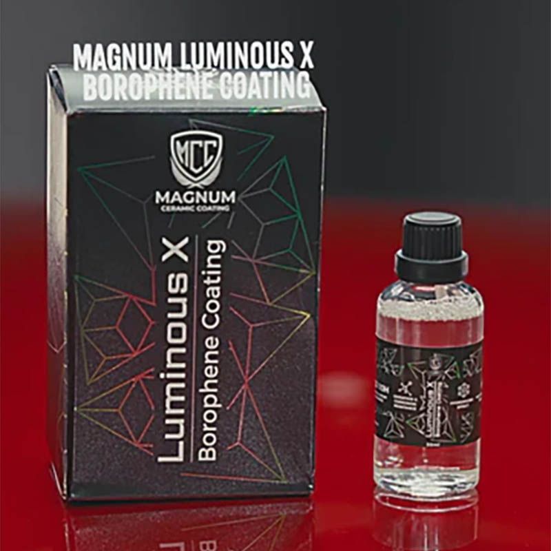 Magnum Luminous X borophene coating box beside a small clear bottle on a red surface