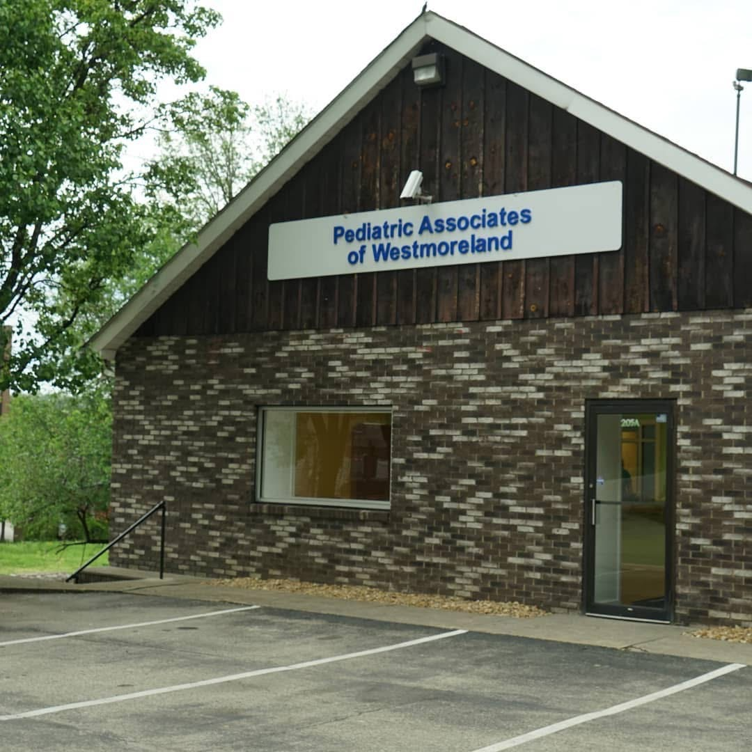 A brick building with a sign that says Pediatric Associates of Westmoreland.