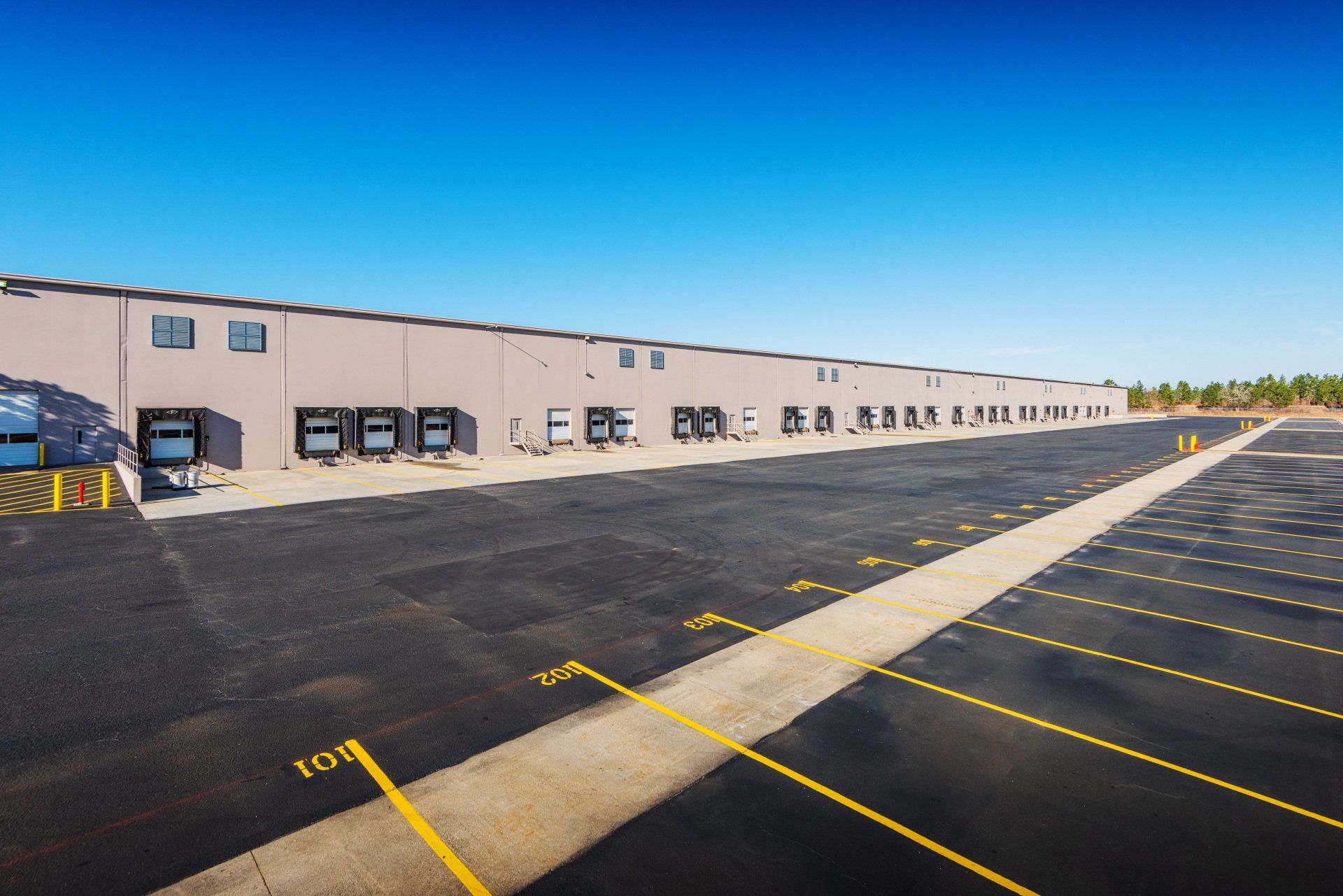 A large building with a lot of parking spaces in front of it.