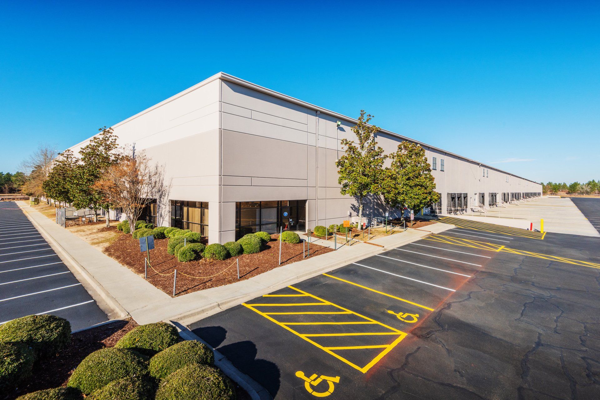 A large building with a handicapped parking spot in front of it.