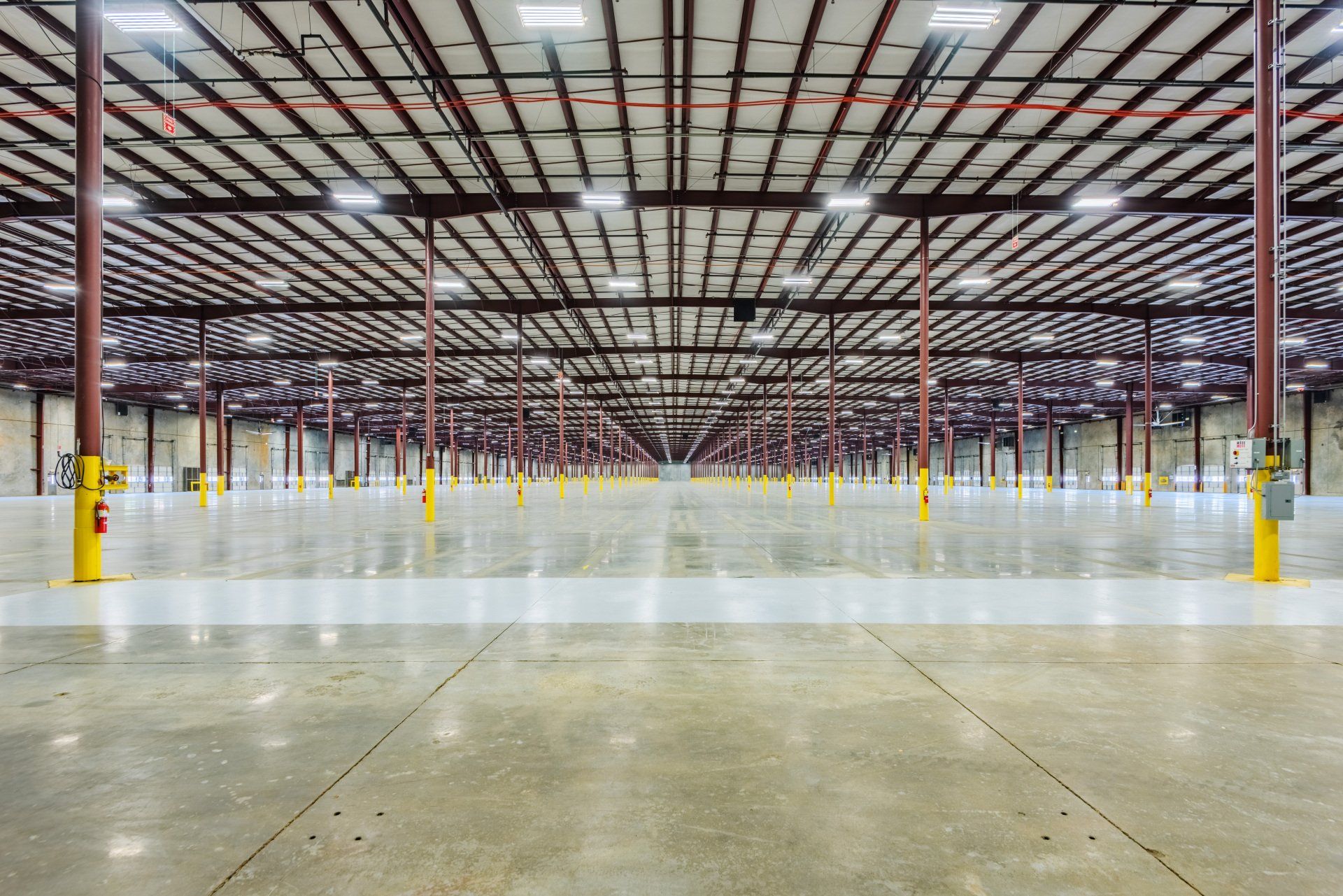 A large empty warehouse with a concrete floor and ceiling.