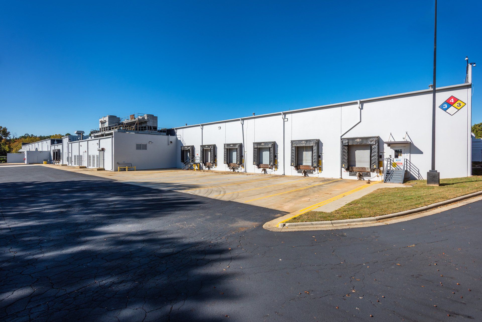 A large white building with a lot of loading docks on the side of it.