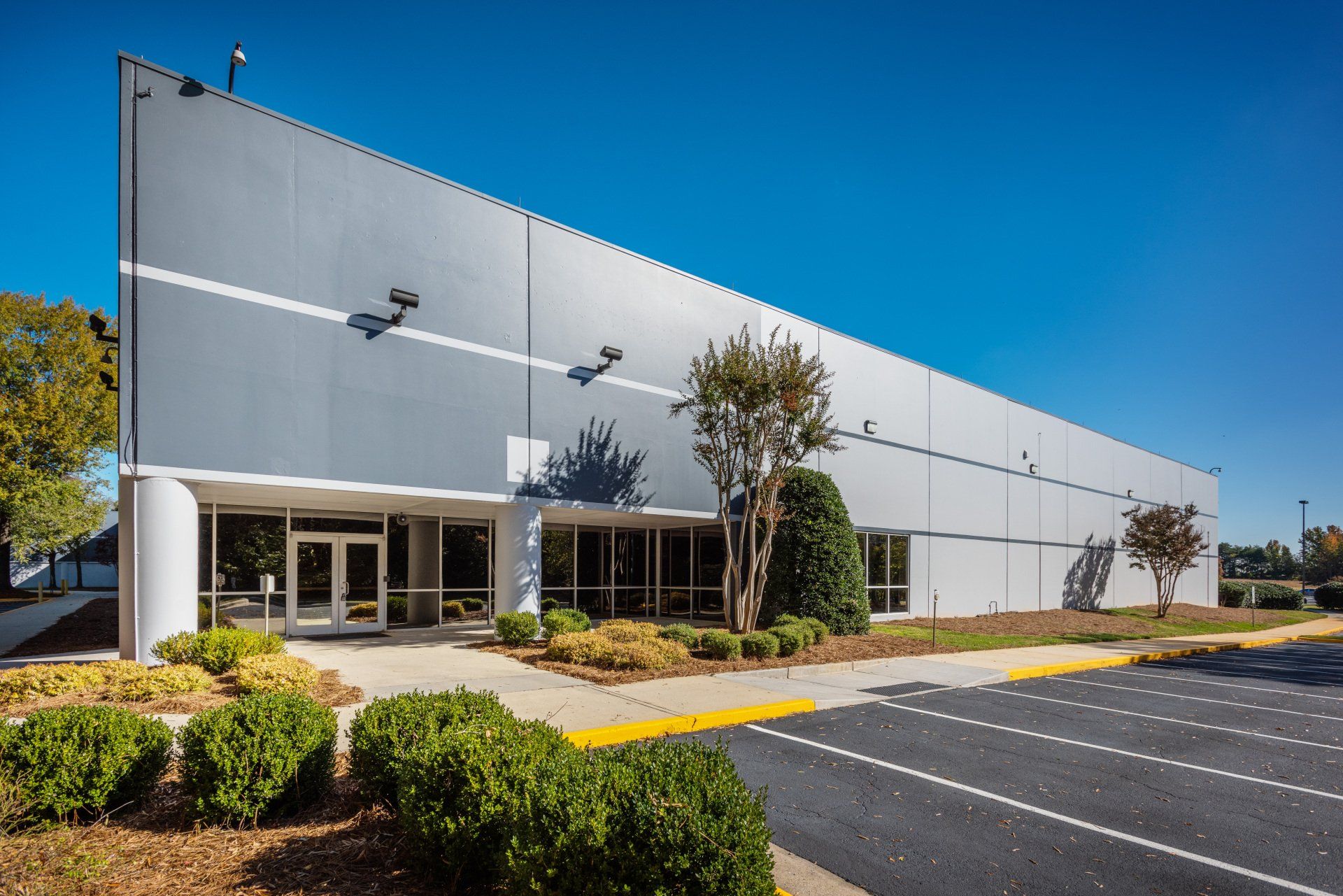 A large building with a parking lot in front of it