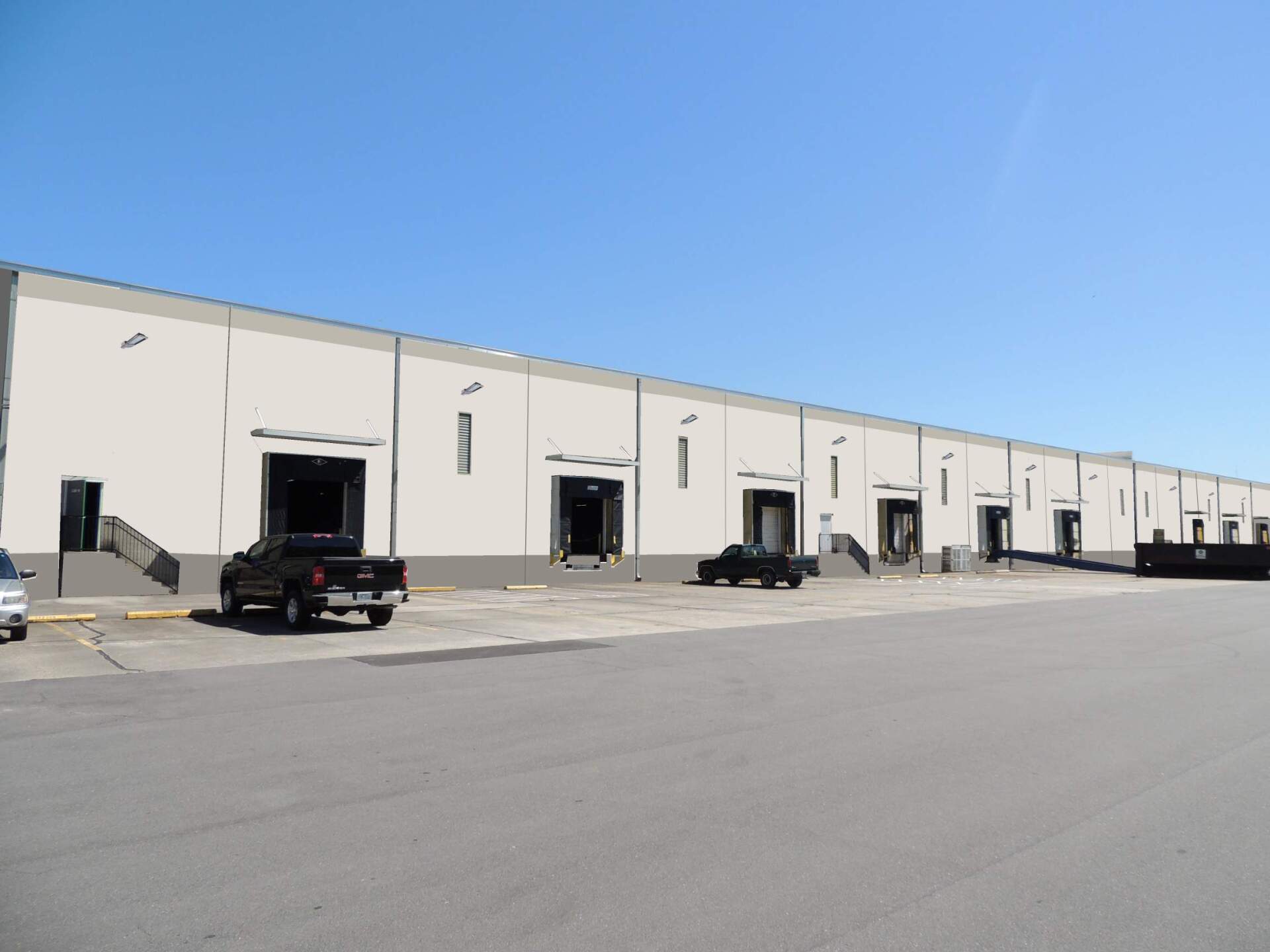A warehouse with trucks parked in front of it