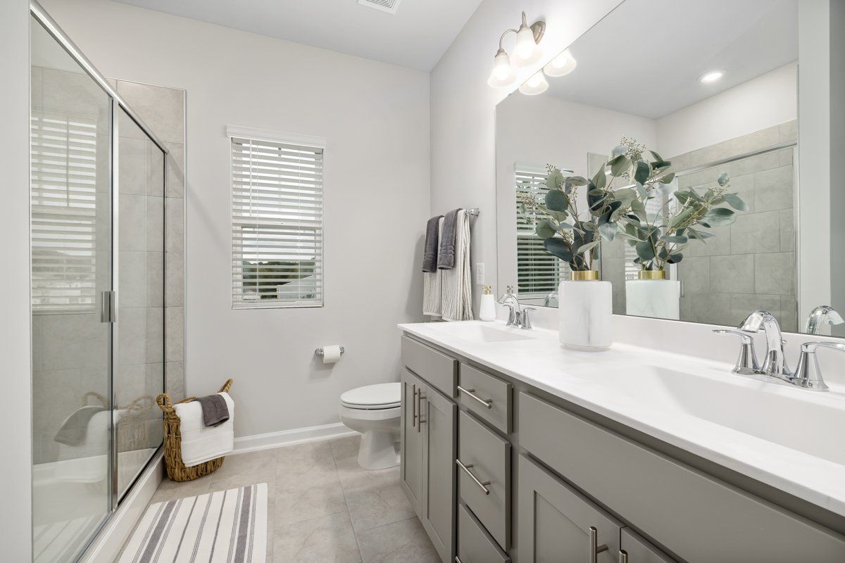A bathroom with a sink , toilet , and shower.
