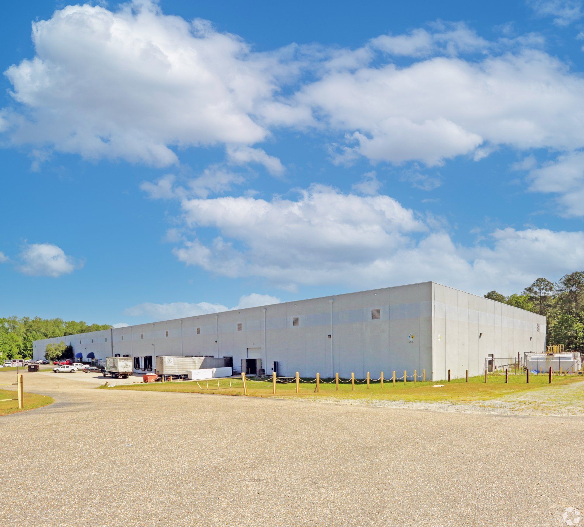 A large white building with a blue sky in the background