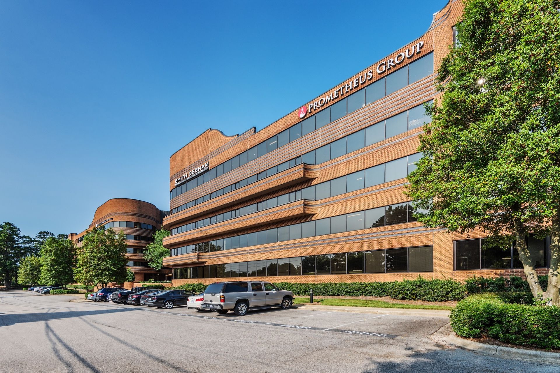 A large brick building with cars parked in front of it