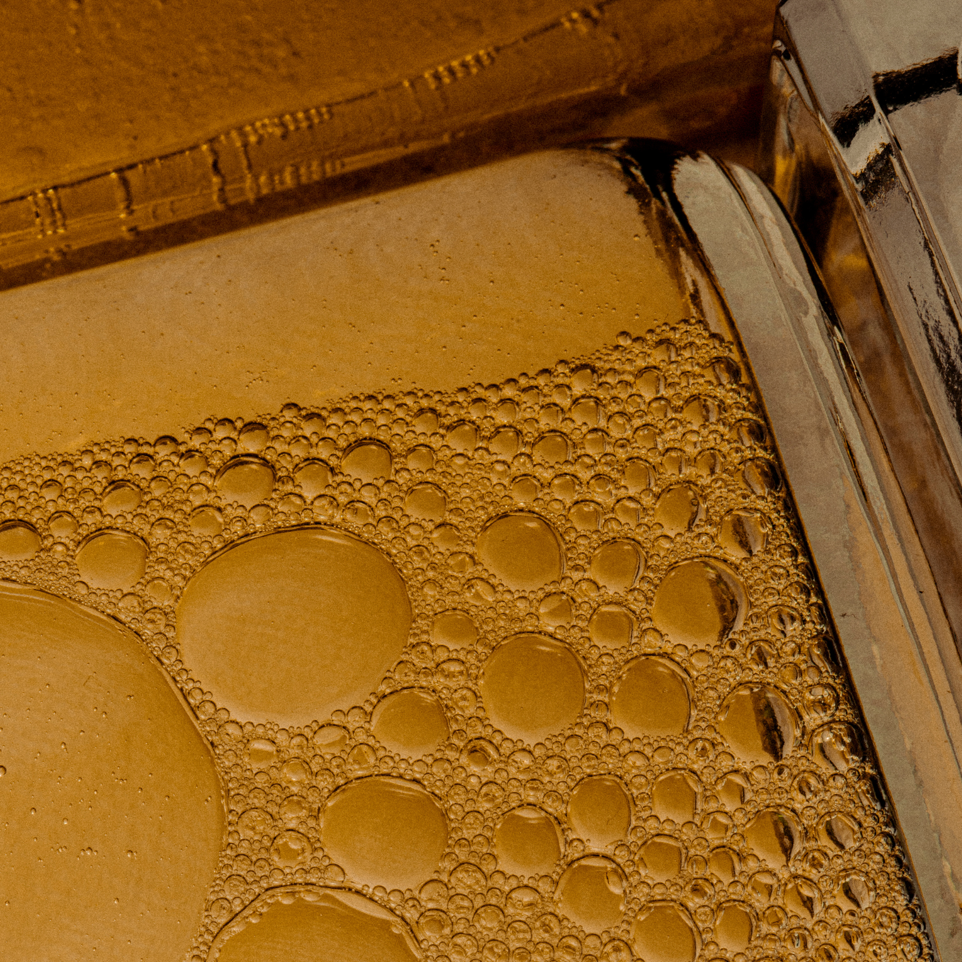 close up image of body oil in glass bottle