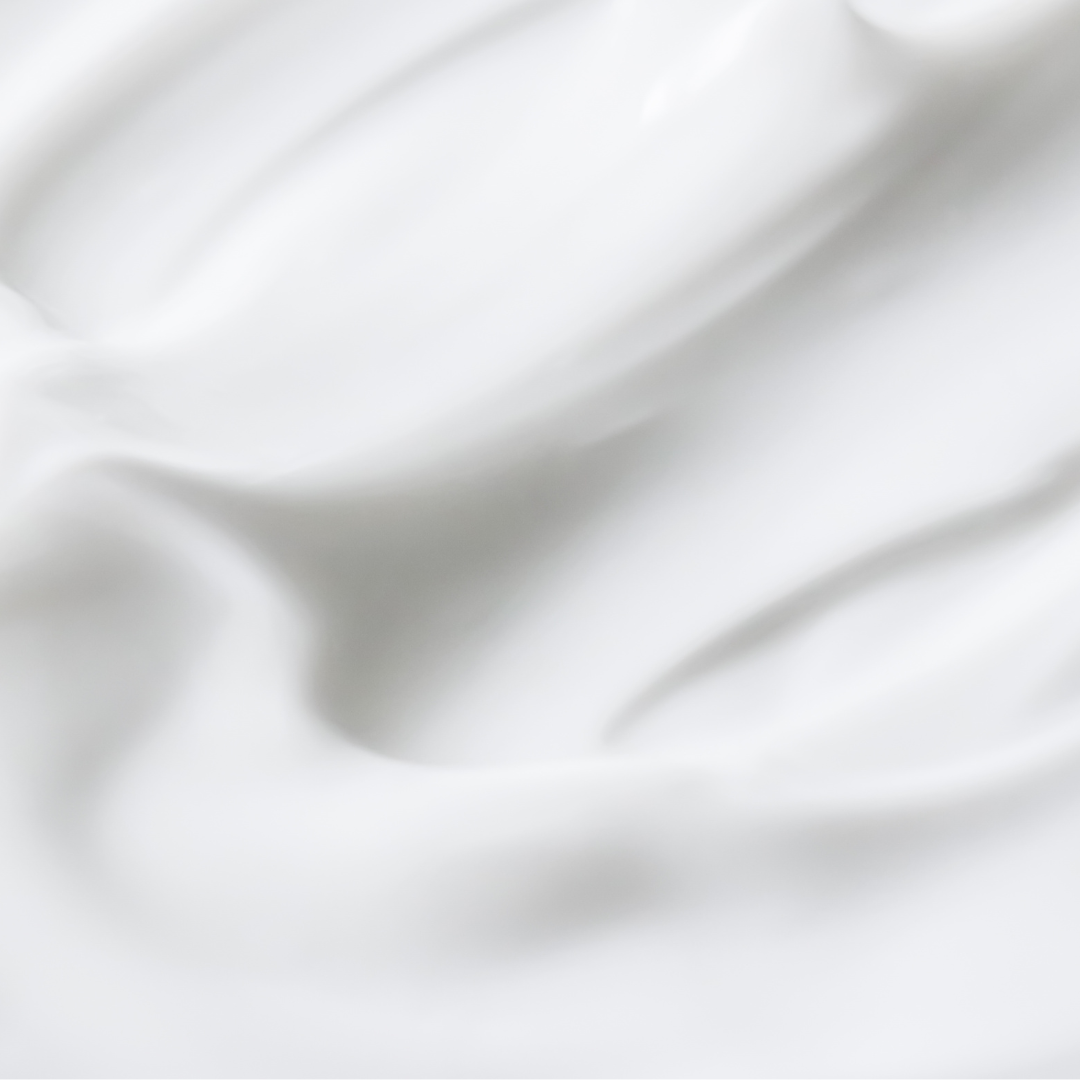 close up image of white body lotion
