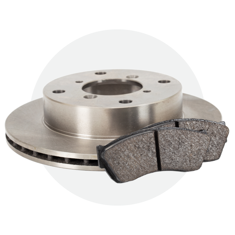 A close up of a brake disc and pads on a white background