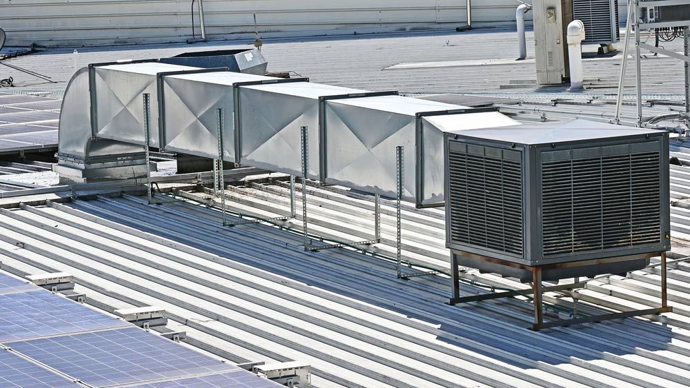 A Rooftop With A Lot Of Air Ducts On It — Priest Airconditioning in Ashmont, NSW