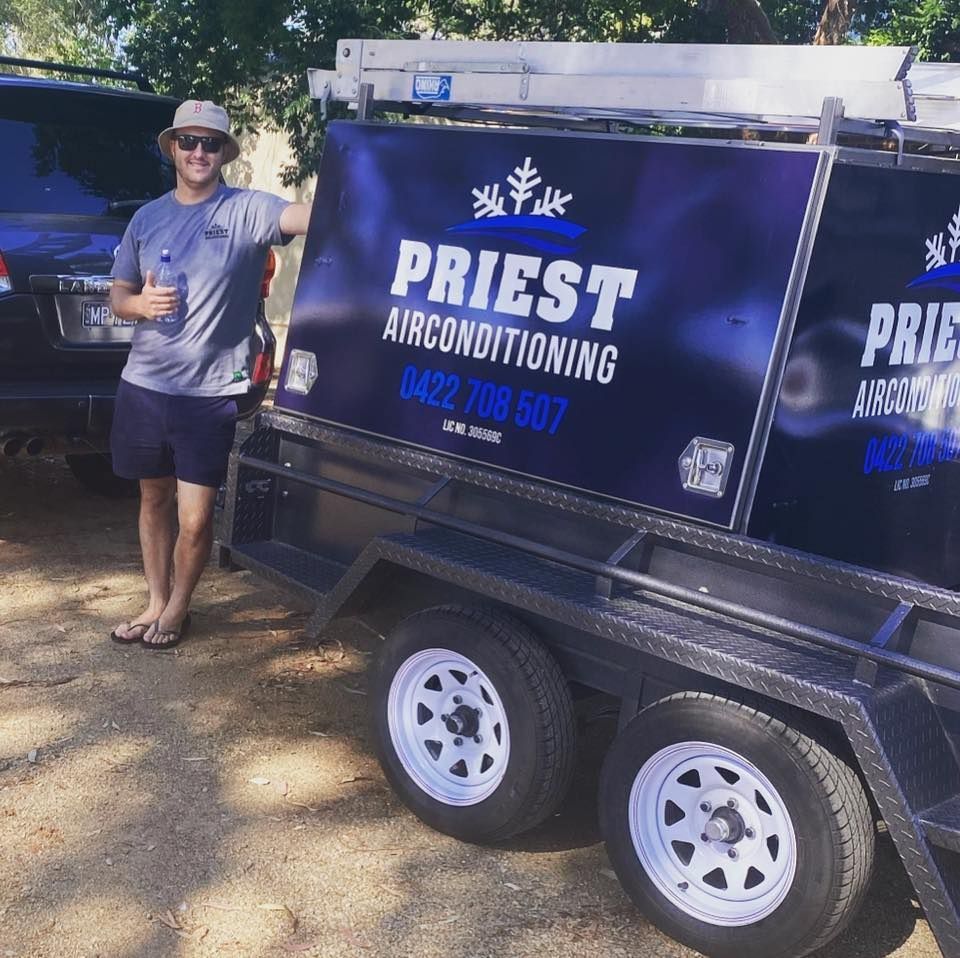 Man Is Standing Beside A Truck — Priest Airconditioning in Ashmont, NSW