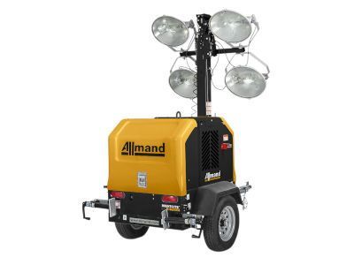 A yellow and black trailer with a tower of lights on it.