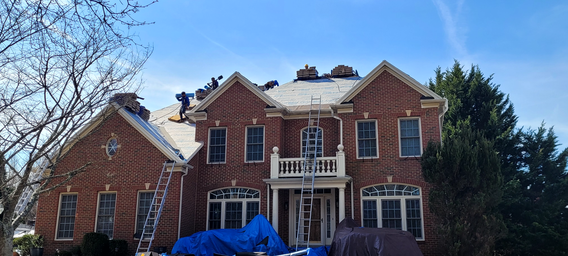 a group of people are working on the roof of a house